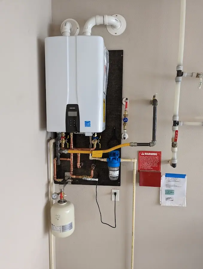 Professional plumber installing copper piping in a Trafford home